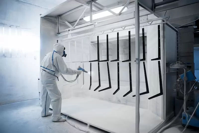 powder coating man in white jumpsuit